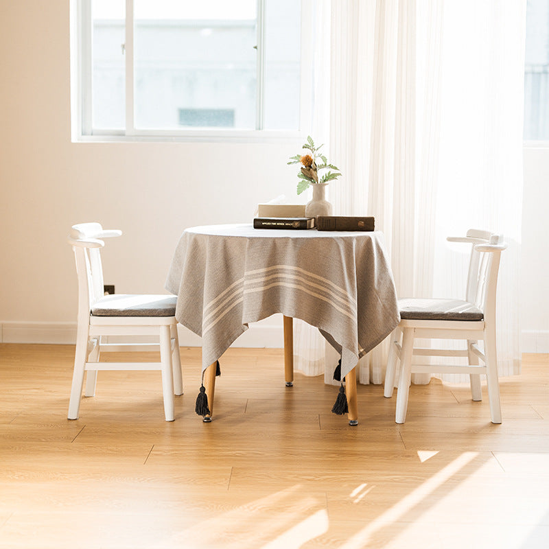 Rectangular linen look tablecloth with fringed tassels and side stripe border design Stornfield