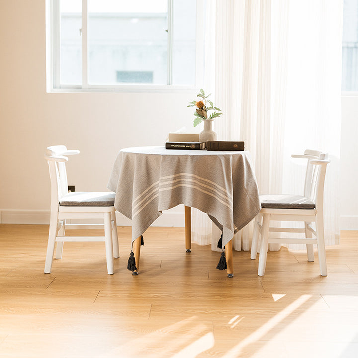 Rectangular linen look tablecloth with fringed tassels and side stripe border design Stornfield