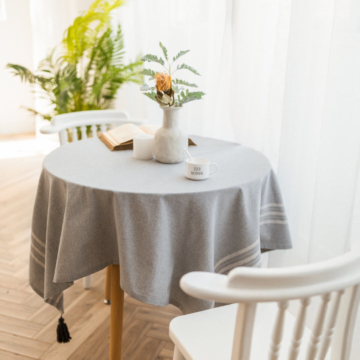 Rectangular linen look tablecloth with fringed tassels and side stripe border design Stornfield