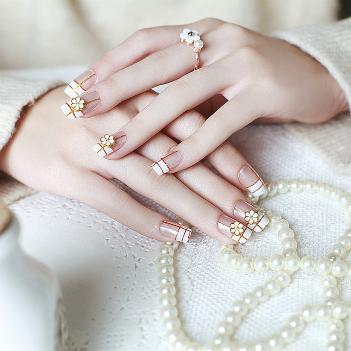 Artificial nails with elegant 3D flower accents and gold trim Stornfield