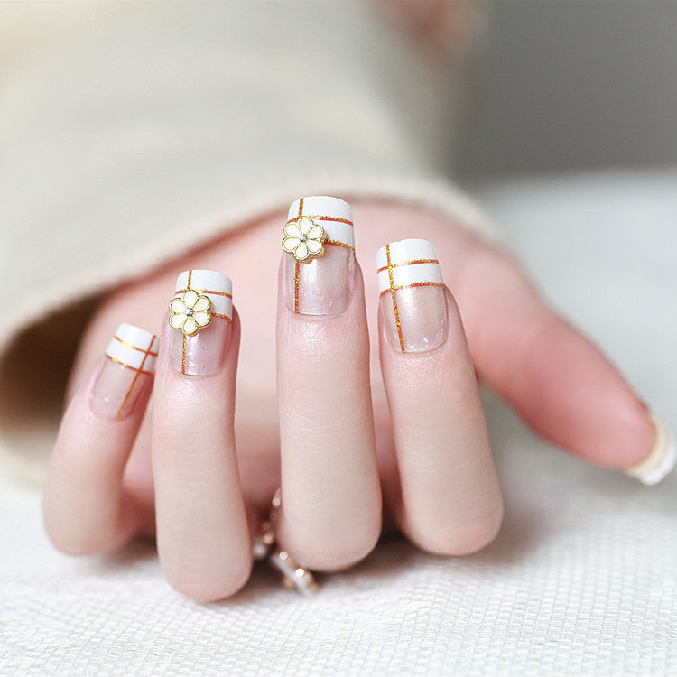 Artificial nails with elegant 3D flower accents and gold trim Stornfield