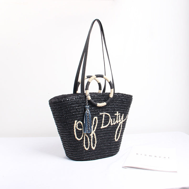 Designer shoulder bag with playful lettering and decorative tassel detail Stornfield