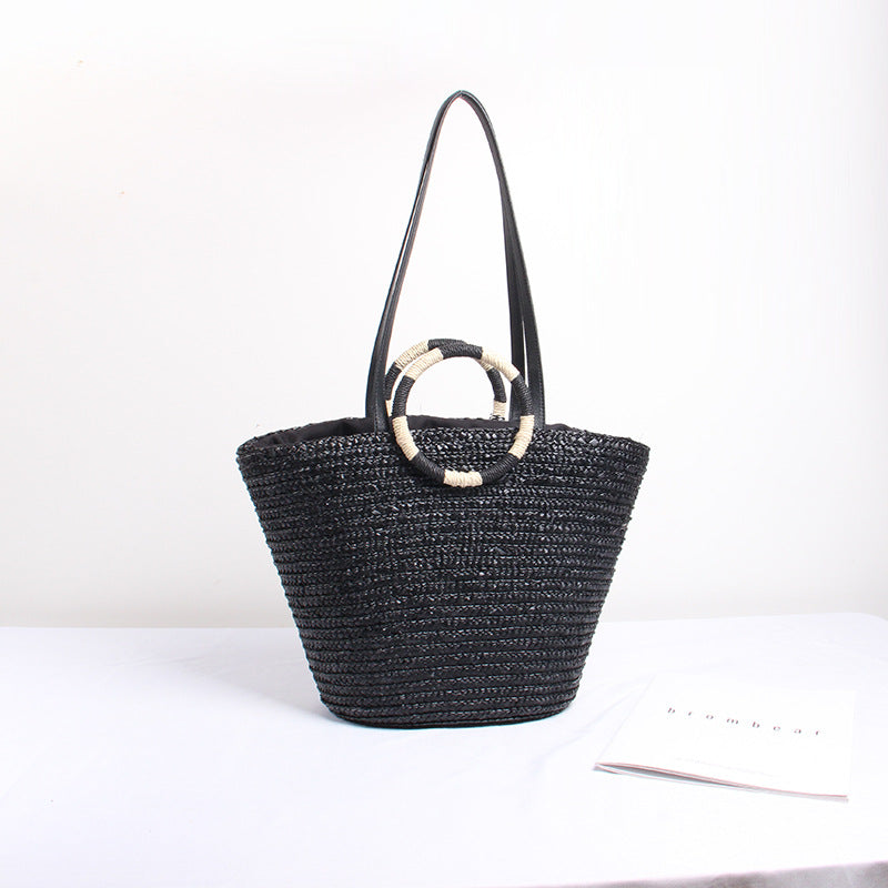 Designer shoulder bag with playful lettering and decorative tassel detail Stornfield