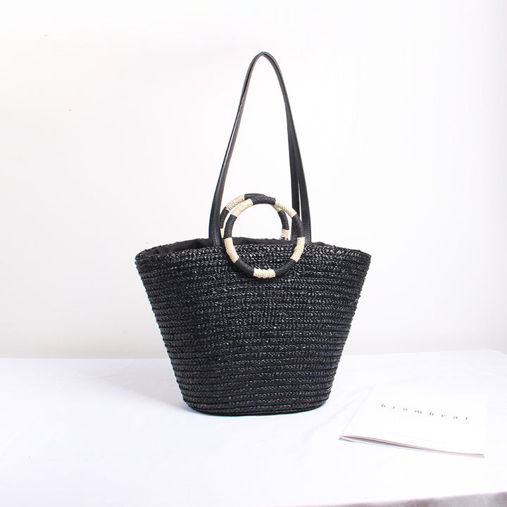 Designer shoulder bag with playful lettering and decorative tassel detail Stornfield
