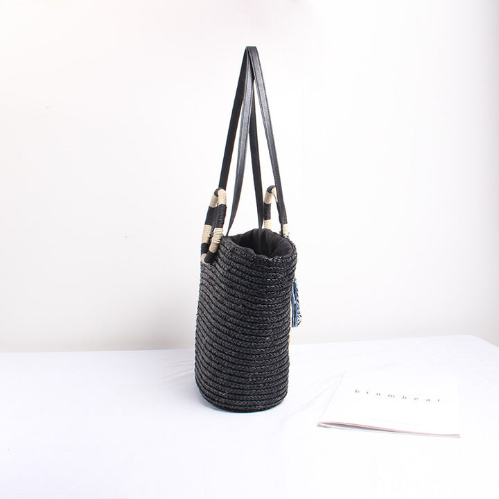 Designer shoulder bag with playful lettering and decorative tassel detail Stornfield