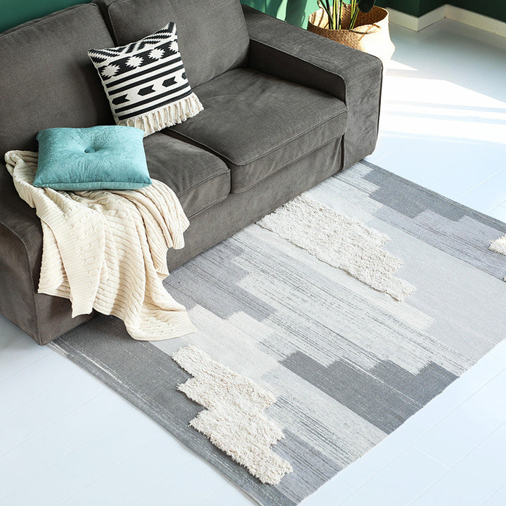 Modern woven living room rug with abstract structure and tufted high-pile accents Stornfield