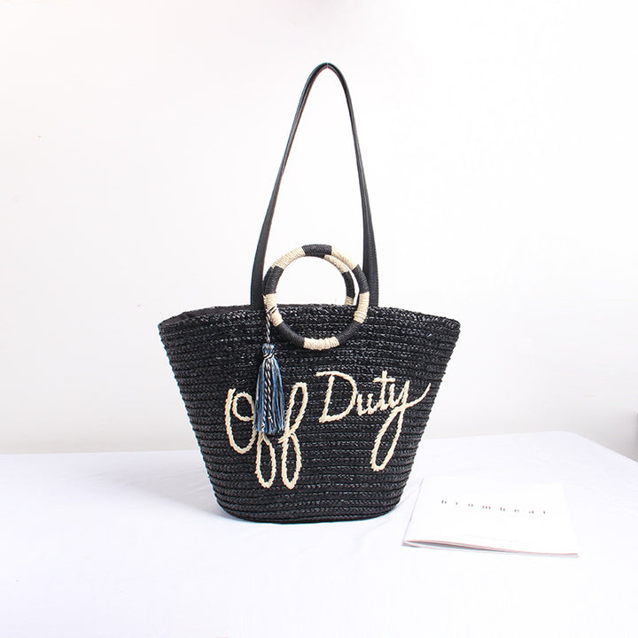Designer shoulder bag with playful lettering and decorative tassel detail Stornfield