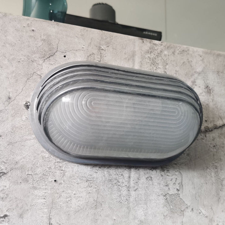 Contemporary Industrial Waterproof Aluminum Glass Frosted Oval Striped 1-Light Wall Sconce Lamp For Outdoor Patio | Stornfield
