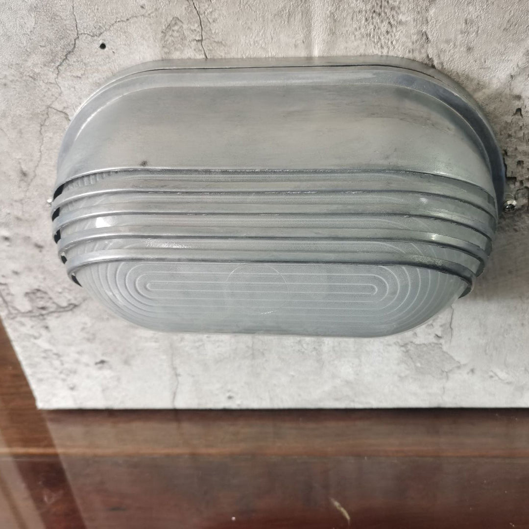 Contemporary Industrial Waterproof Aluminum Glass Frosted Oval Striped 1-Light Wall Sconce Lamp For Outdoor Patio | Stornfield