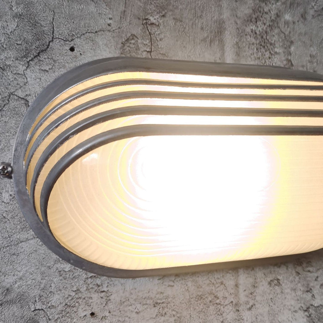 Contemporary Industrial Waterproof Aluminum Glass Frosted Oval Striped 1-Light Wall Sconce Lamp For Outdoor Patio | Stornfield