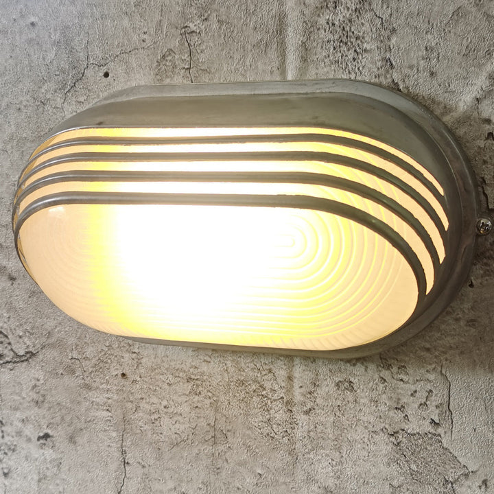 Contemporary Industrial Waterproof Aluminum Glass Frosted Oval Striped 1-Light Wall Sconce Lamp For Outdoor Patio | Stornfield