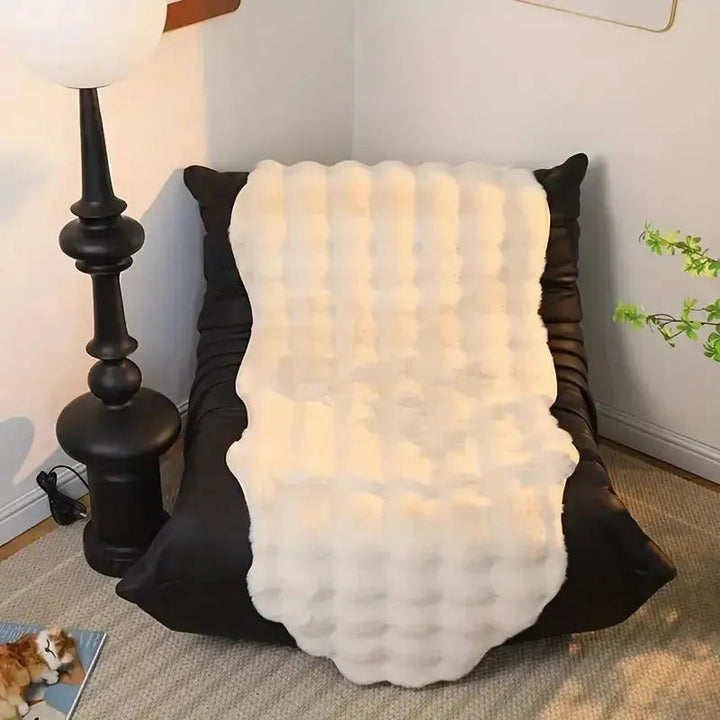 Ultra-soft plush throw with non-slip Stornfield backing