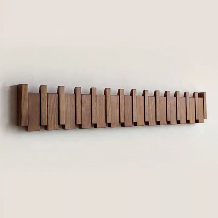 Wooden coat rack in piano design with foldable hooks | Stornfield