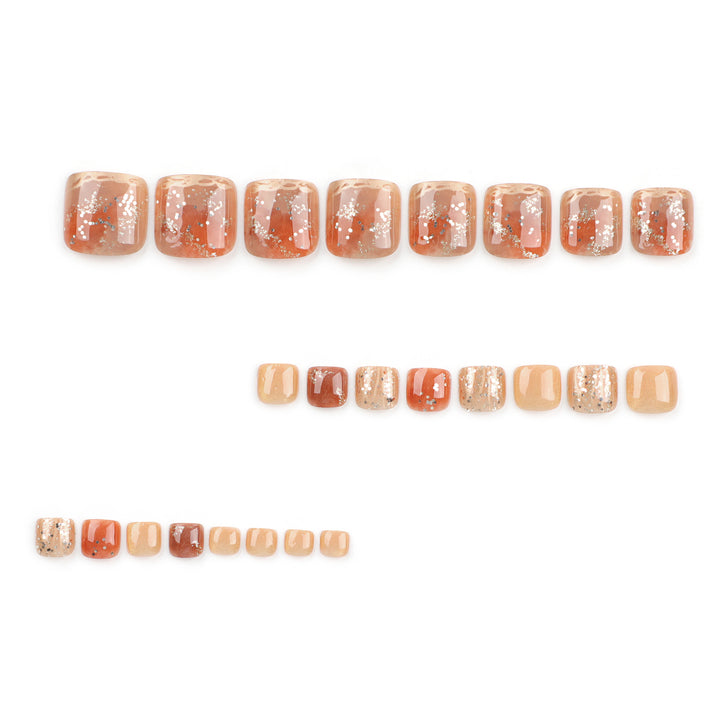 Artistic toenail design with glitter and golden accents Stornfield