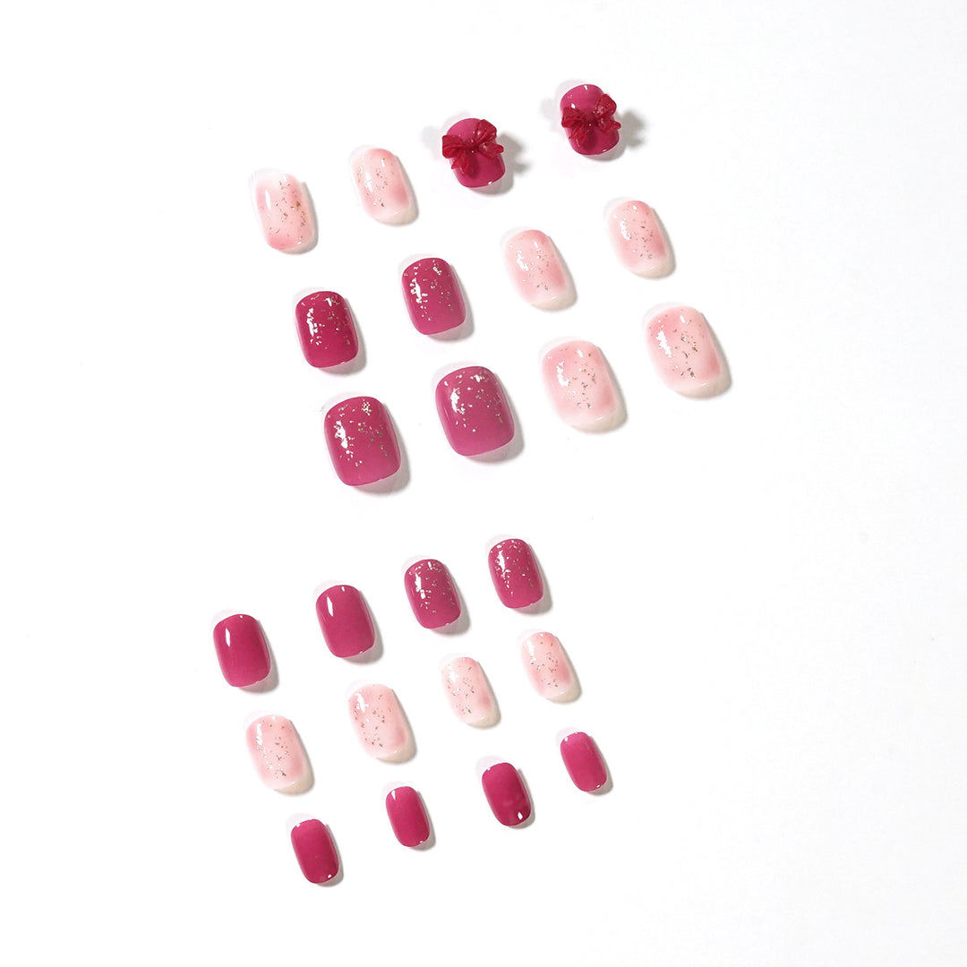 Artificial nail art with glitter embellishments and cute bow motif Stornfield