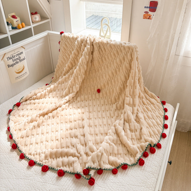 Cuddly blanket with crocheted rose trim and plush texture