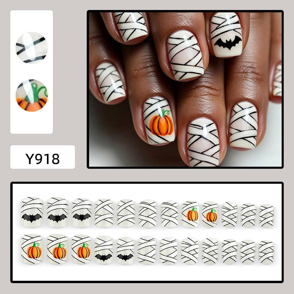 Creative Halloween Nail Art with Pumpkin and Bat Design Stornfield