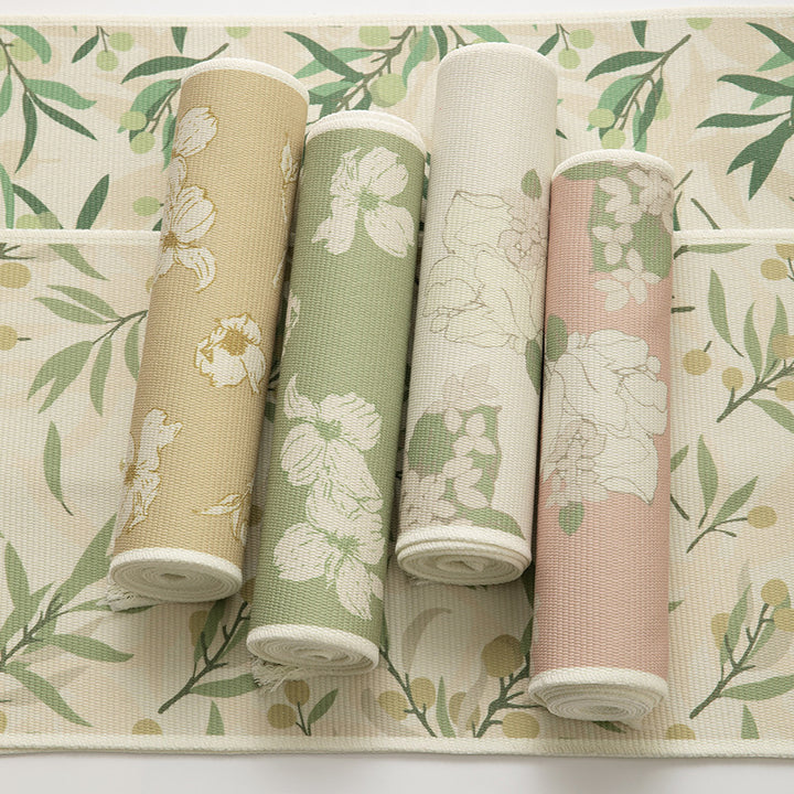 Woven botanical table runner with olive branch motif and fringed edge