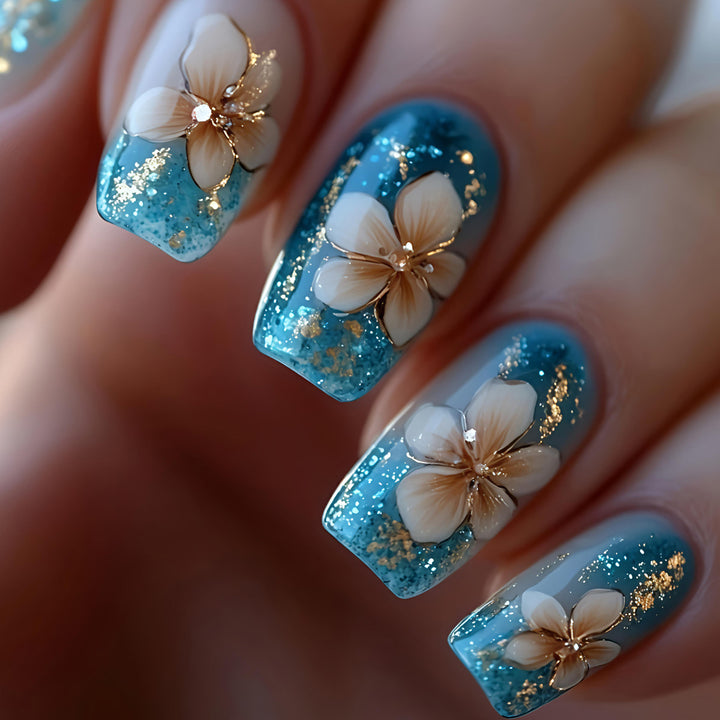Artificial nails with floral accents and glitter patterns Stornfield