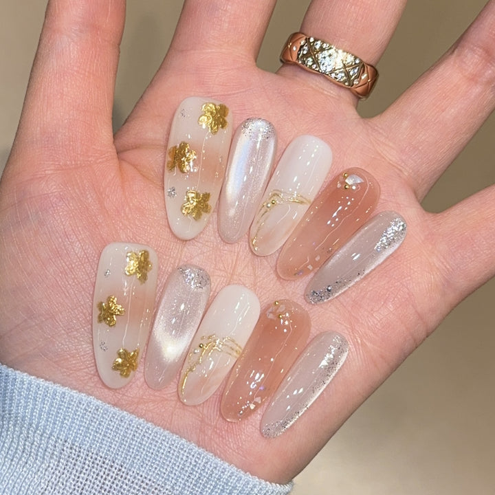 Artificial nails with floral decorations and glitter effects Stornfield