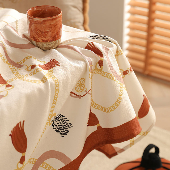 Rectangular tablecloth made of easy-care polyester blend fabric with decorative tassel and ribbon motif and contrasted hem