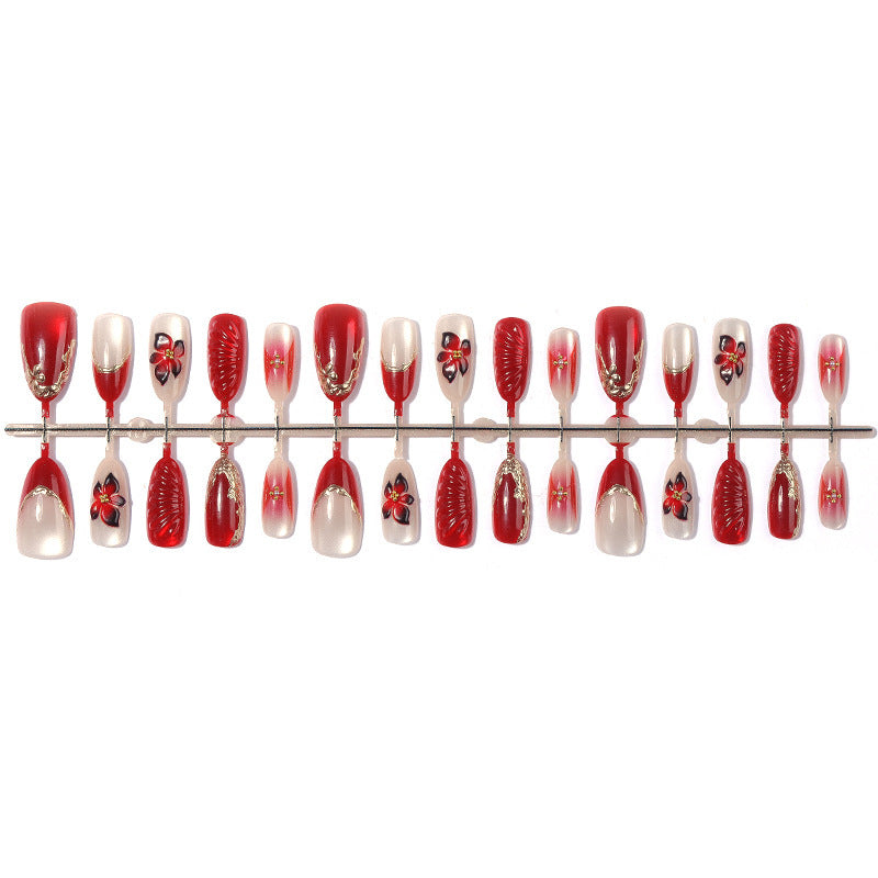Artificial nail set with elegant floral details and glitter accents Stornfield