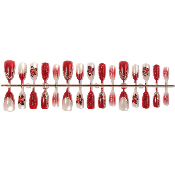 Artificial nail set with elegant floral details and glitter accents Stornfield