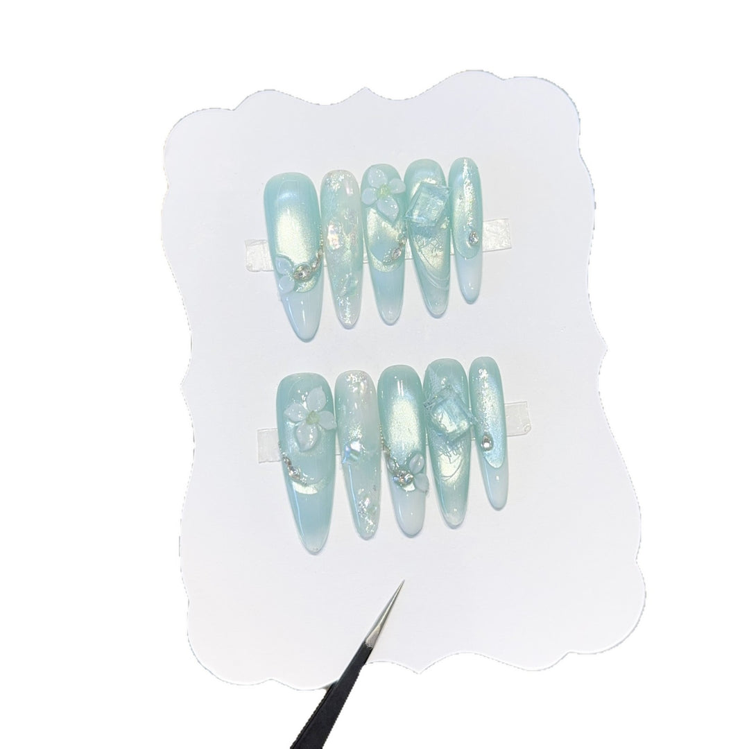 Artificial nails with floral designs and glitter effects Stornfield