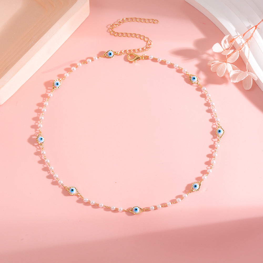 Elegant Pearl and Eye Charm Necklace Stornfield