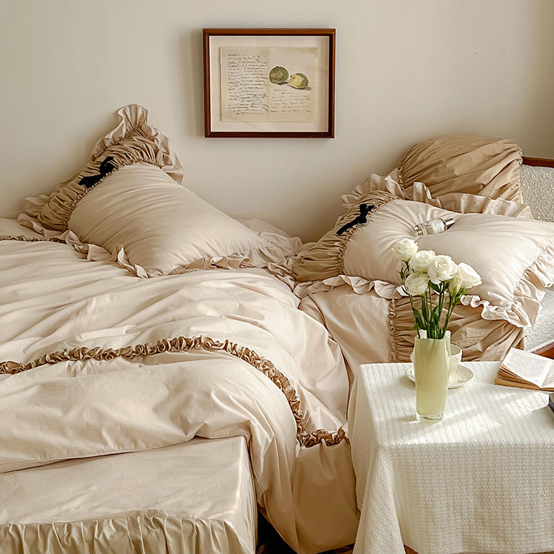 Luxurious satin bedding set with gathered ruffle, braided decorative ribbons and bow appliqué