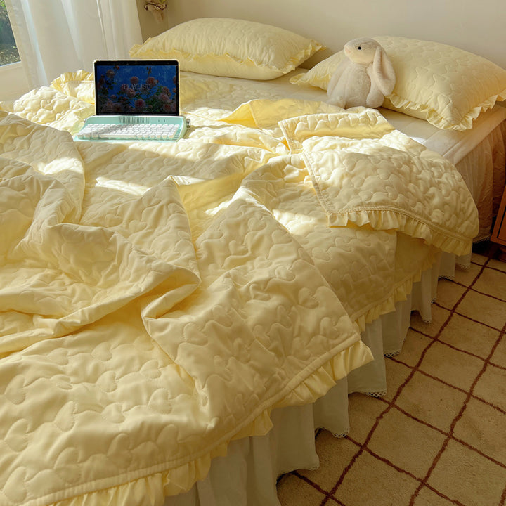 Quilted bedspread set with frill edge and heart quilting pattern