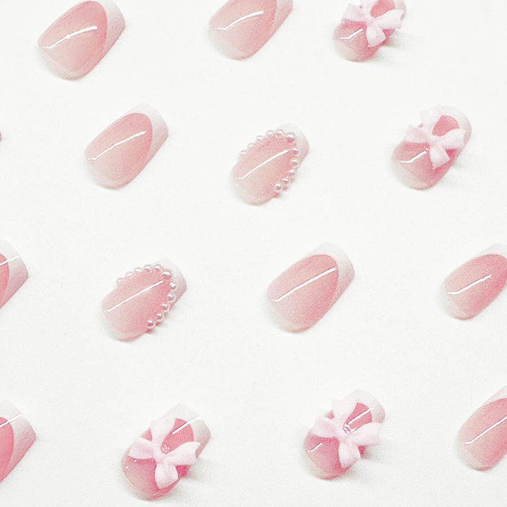 Artificial nails with elegant bows and pearl embellishments Stornfield