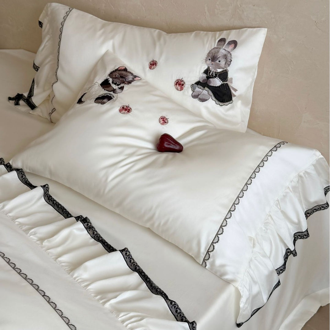 Embroidered satin bedding set with frill, ruffled hem, and animal motif