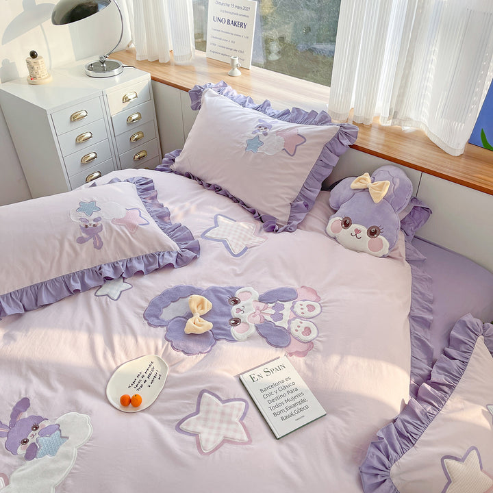 Children's bedding set with plush appliqués, ruffled flounces, and embroidery
