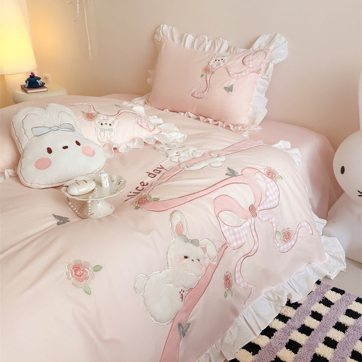 Romantic cotton satin bedding set with ruffles, plush appliqués and fine embroidery