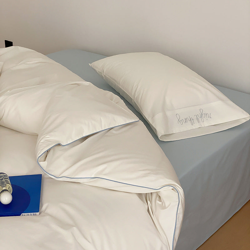 Cotton satin bed linen set with contrasting piping and subtle brand embroidery