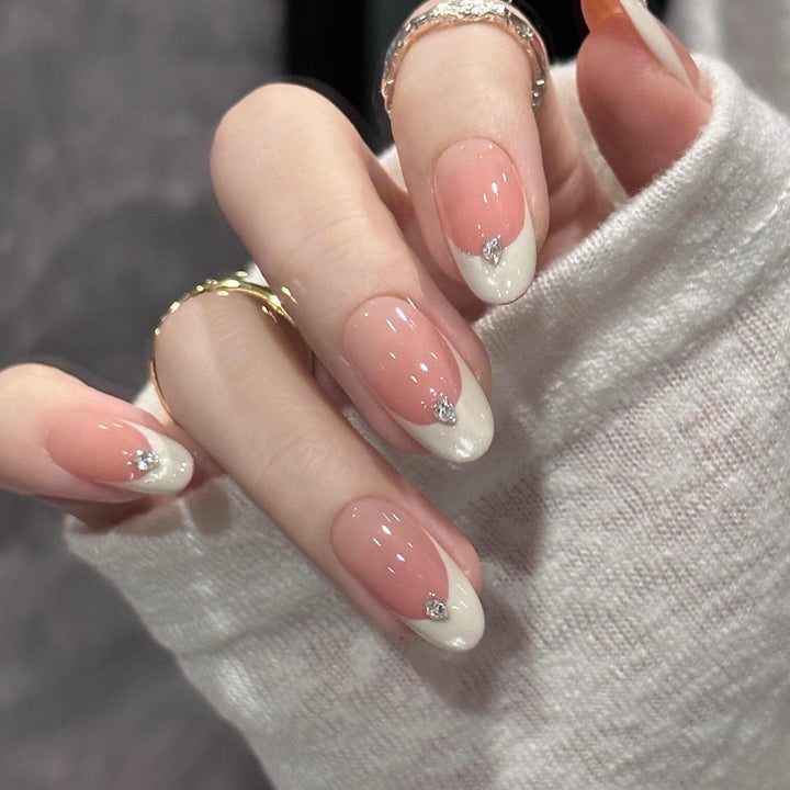 Artificial nails with elegant French style and sparkling accents Stornfield