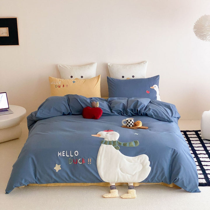 Children's bedding set with appliquéd duck figure, embroidered details, and extra soft microfiber cover