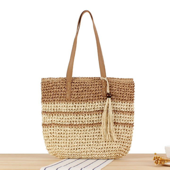 Handbag made of braided natural material with decorative tassel pendant Stornfield