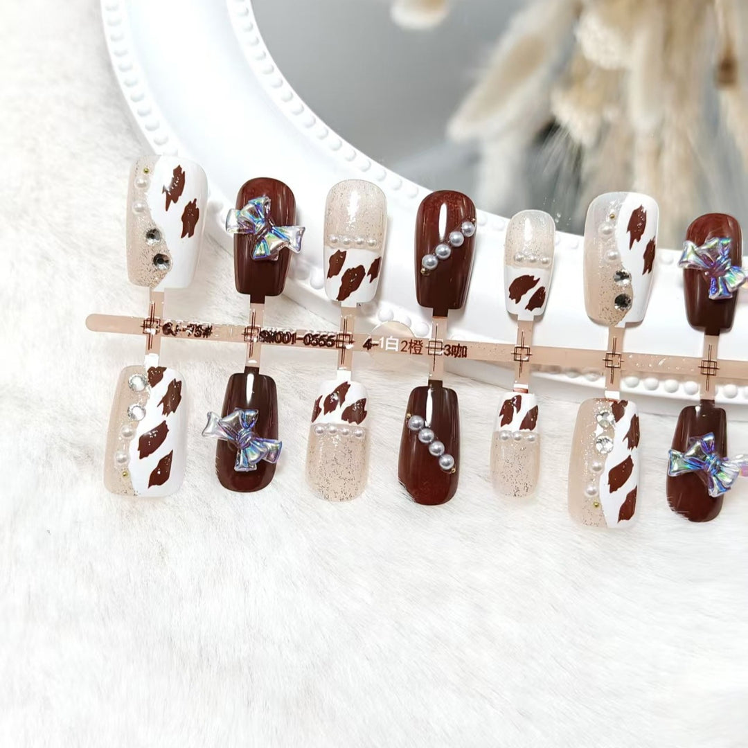 Artificial nails with sparkling rhinestone and bow accents Stornfield