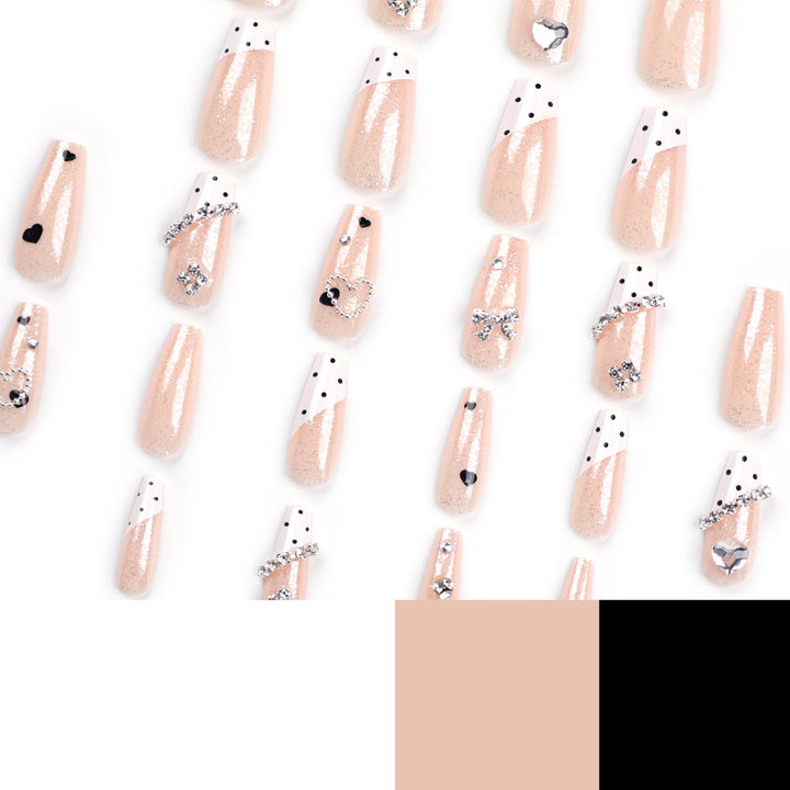 Artful nail extensions with elegant rhinestone and heart designs Stornfield