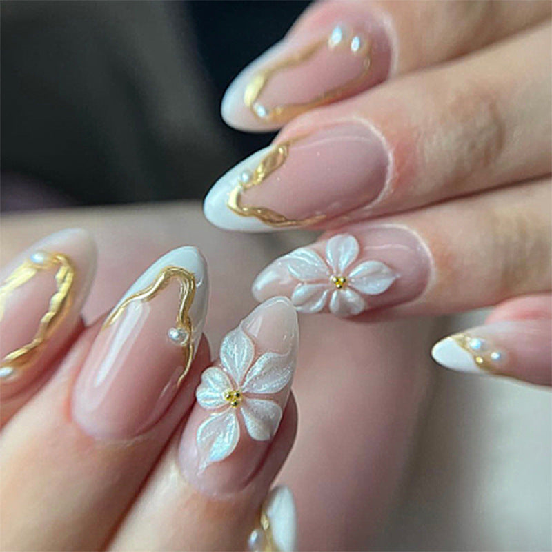 Artificial nail set with elegant gold accents and floral decorations Stornfield