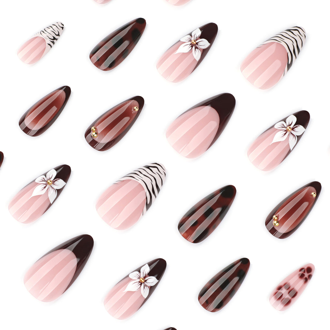 Artistic stiletto nails with elegant floral designs and glitter accents Stornfield