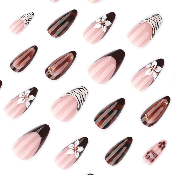 Artistic stiletto nails with elegant floral designs and glitter accents Stornfield