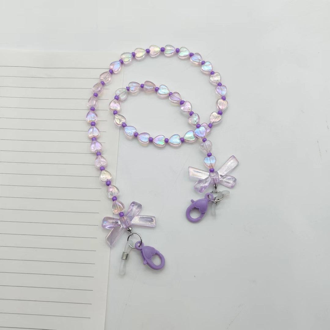 Fashionable glasses holder chain with heart and flower motifs Stornfield
