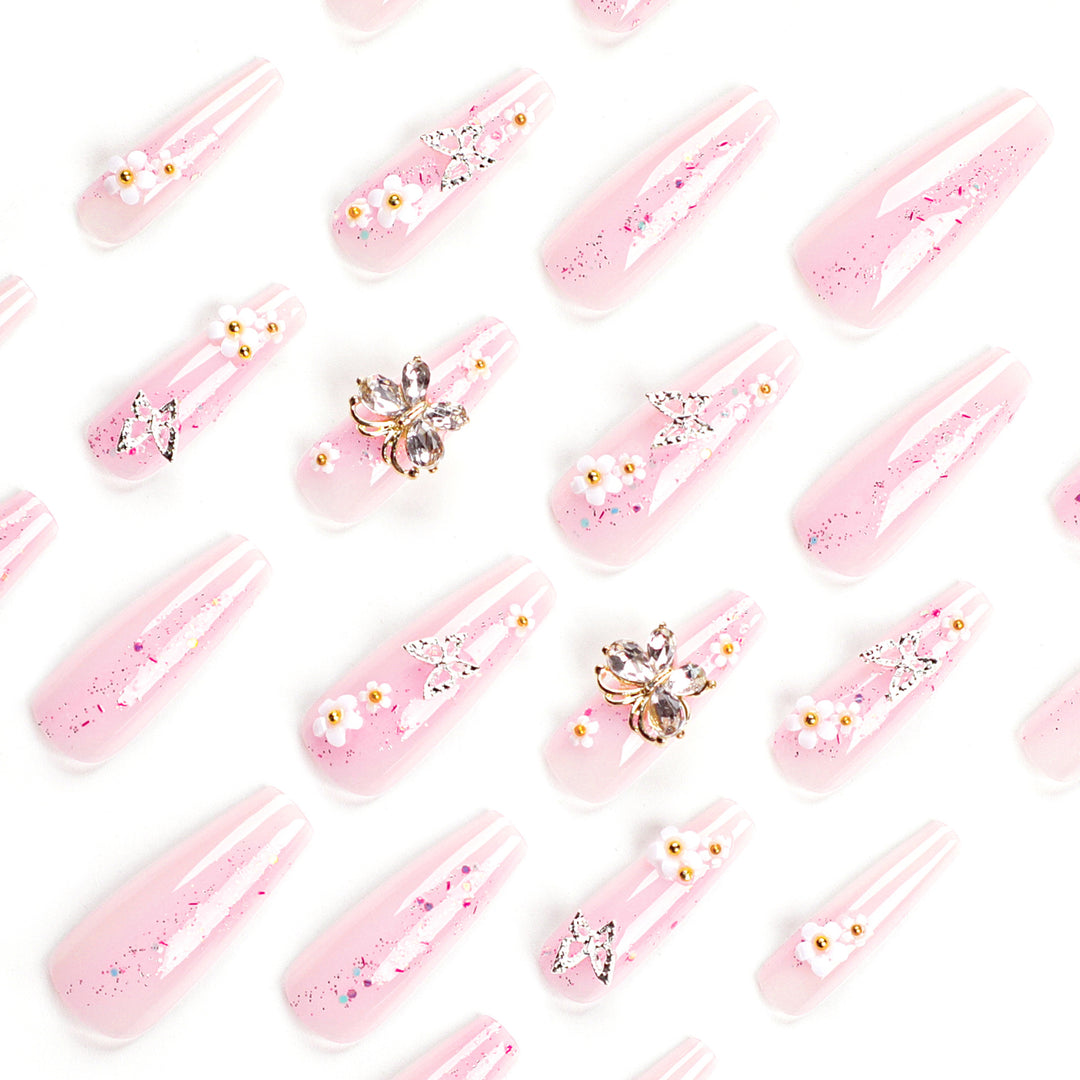 Artistic Nail Extensions with Glitter and Floral Accents Stornfield