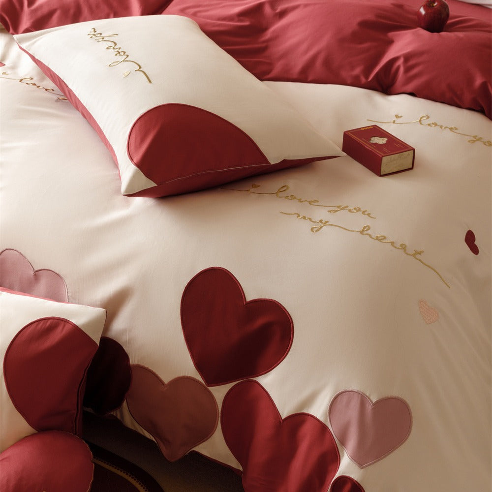 Romantic bedding set made of cotton satin with appliquéd hearts and golden embroidery
