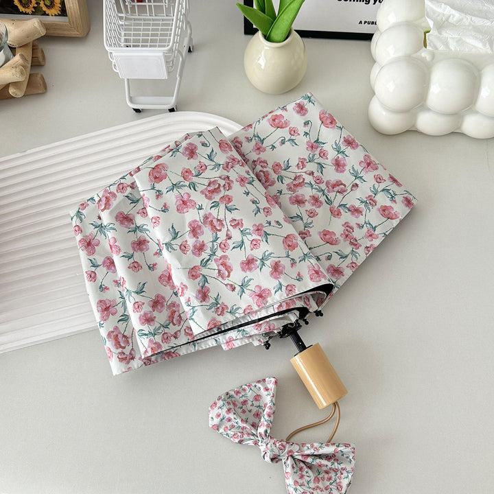 Women's folding umbrella with floral design and practical storage system Stornfield