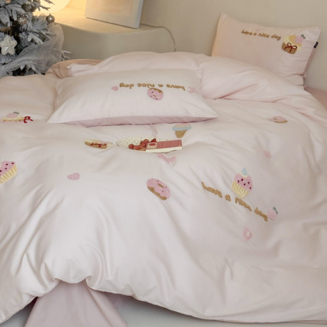 Quilted bedding set with cupcake embroideries and text application