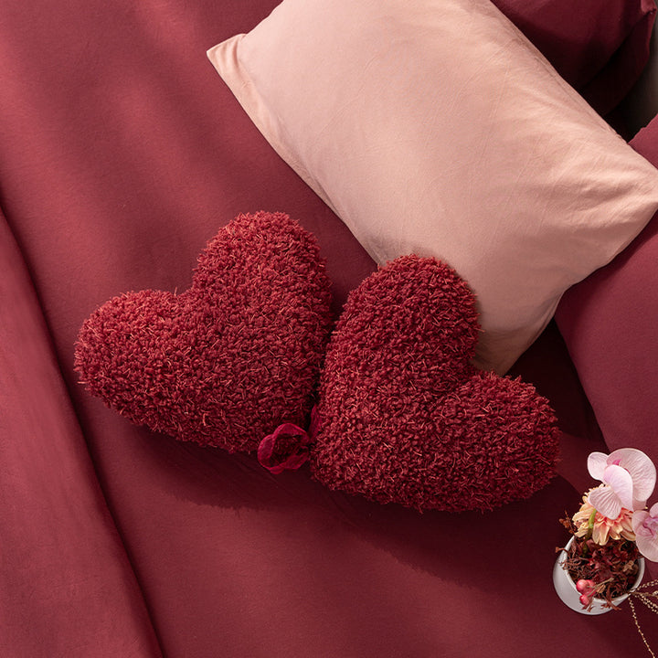 Heart-shaped decorative cushion set made of plush with ribbon and textured teddy surface Stornfield